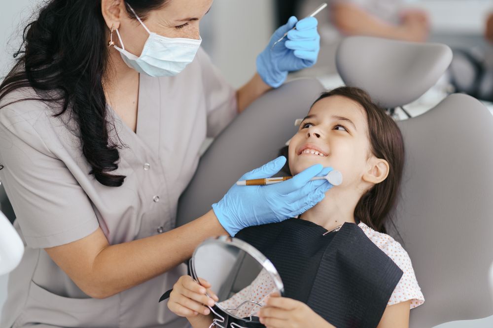 a little girl is having dental treatment