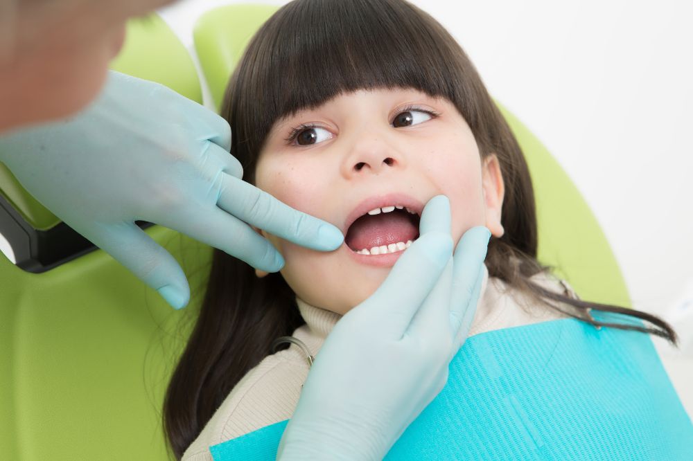 a baby girl is having root canal treatment