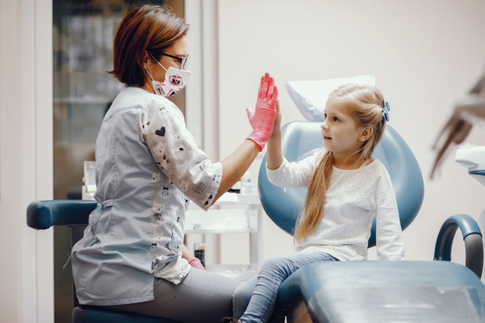 cute ittle girl sitting dentists office